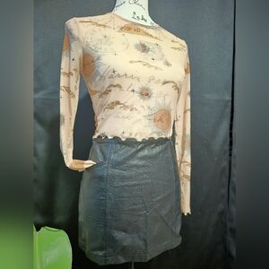Sheer nudes color, crew neck crop top with ruffled edges on sleeves and torso.
